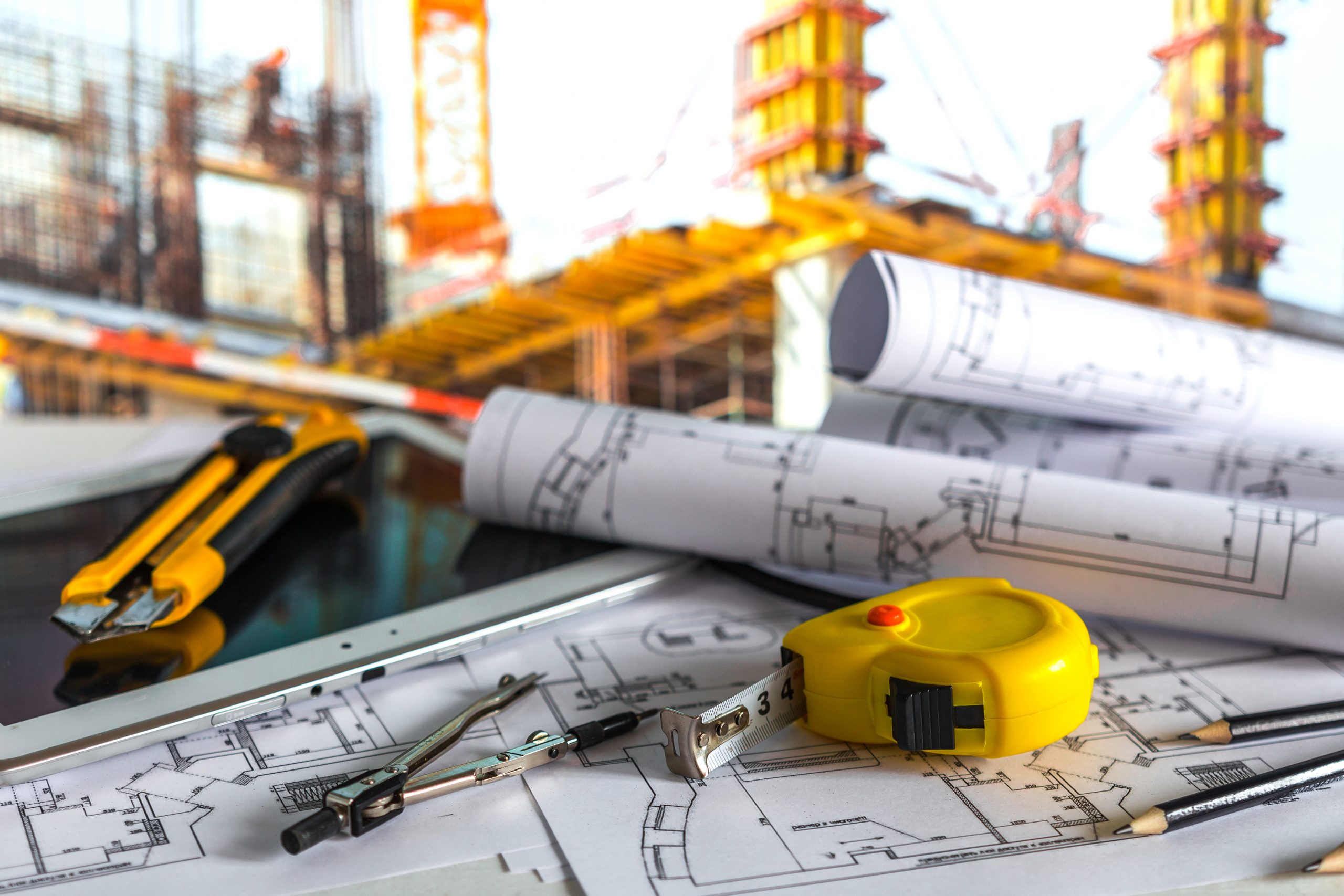house under construction on blueprints - building project